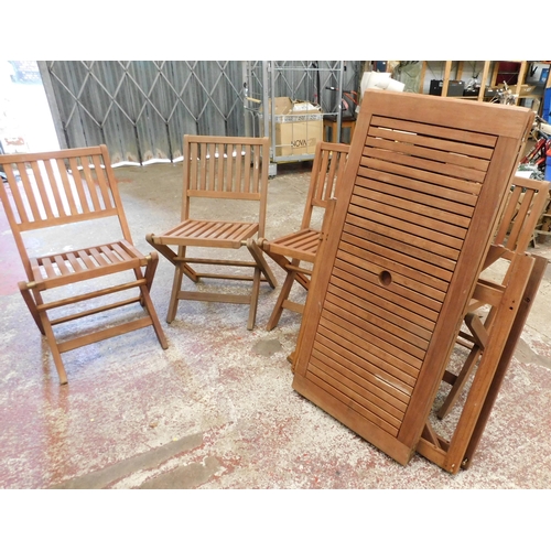 516 - Four wooden folding garden chairs and matching table
