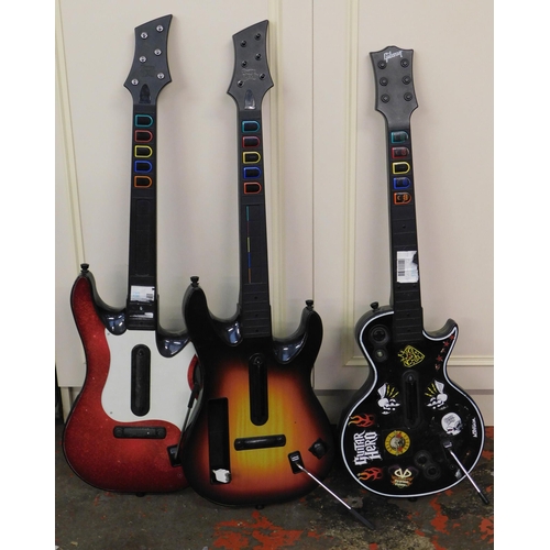 781 - Three assorted game console guitar controllers