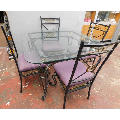 550 - Cast metal and glass top table with four chairs approx. 45