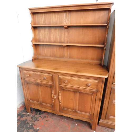 550 - Ercol two door, two drawer dresser with plate shelves