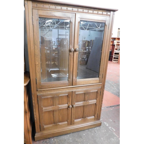 551 - Ercol two door cupboard with two door glazed top