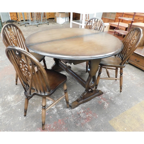 820 - Circular dining table and four wheelback dining chairs