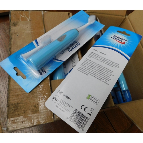 527 - Two boxes of new and carded battery operated toothbrushes and replacement heads