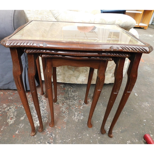 576 - Mahogany coloured nest of three tables