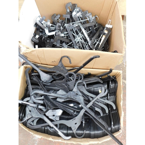 827 - Two boxes of coat hangers