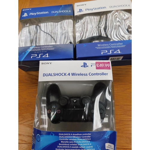 522 - Three boxed PS4 controllers