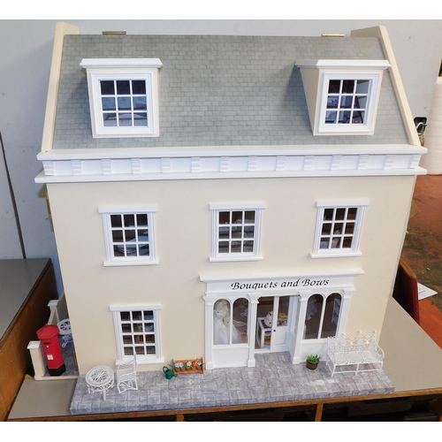 553 - Three storey dolls house with large amount of accessories - porcelain fittings and upholstered furni... 