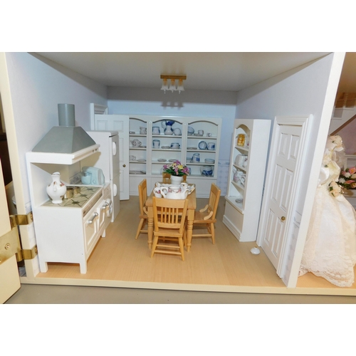 553 - Three storey dolls house with large amount of accessories - porcelain fittings and upholstered furni... 