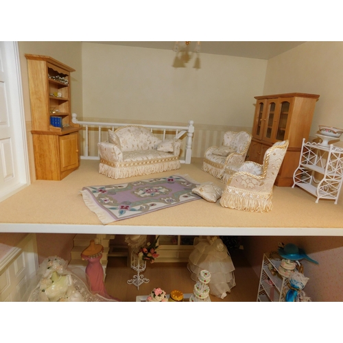 553 - Three storey dolls house with large amount of accessories - porcelain fittings and upholstered furni... 