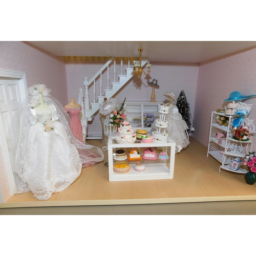 553 - Three storey dolls house with large amount of accessories - porcelain fittings and upholstered furni... 