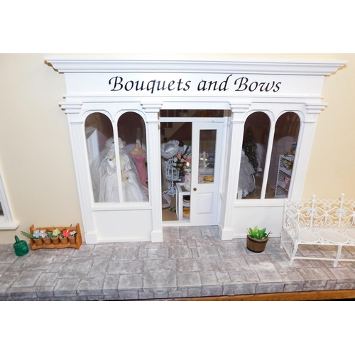 553 - Three storey dolls house with large amount of accessories - porcelain fittings and upholstered furni... 