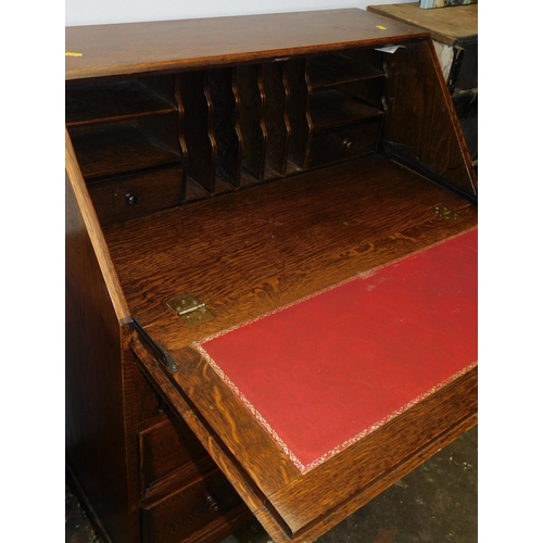 657 - Solid oak drop fronted writing desk with drawers