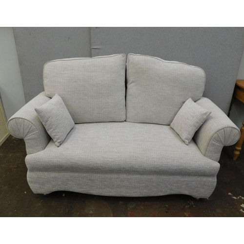 562 - Two seater sofa with hinged arms