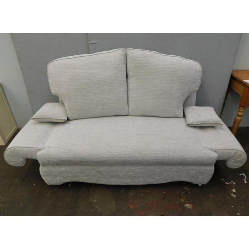 562 - Two seater sofa with hinged arms...