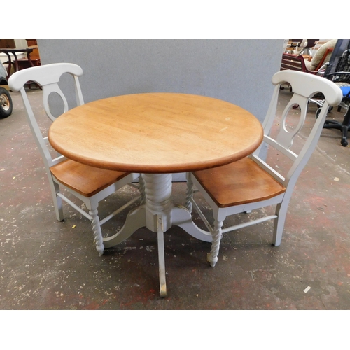563 - Stripped oak table and two chairs with painted bases