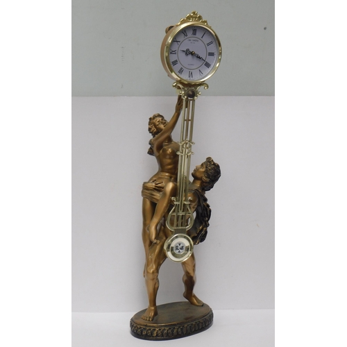 610 - Large figurine with swinging pendulum clock