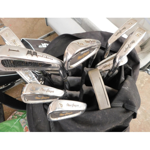 824 - 2 sets of golf clubs including balls, shoes, mat and stand