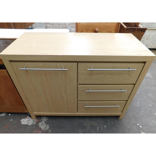 657 - Light oak coloured three drawer cupboard