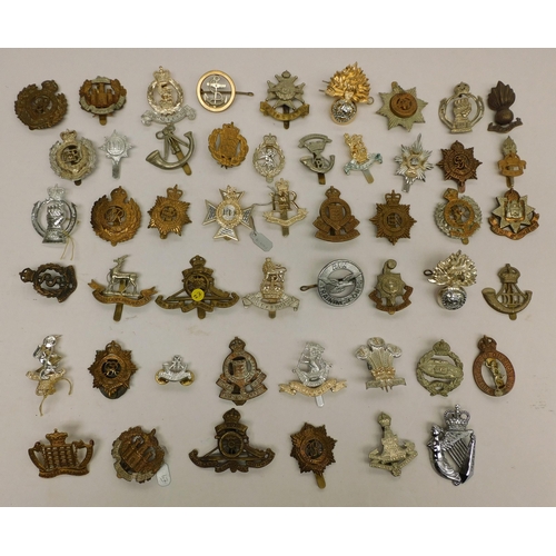 135 - Approximately fifty - military/cap badges