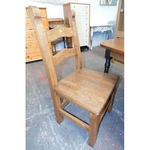 576 - Oak table and four solid chairs