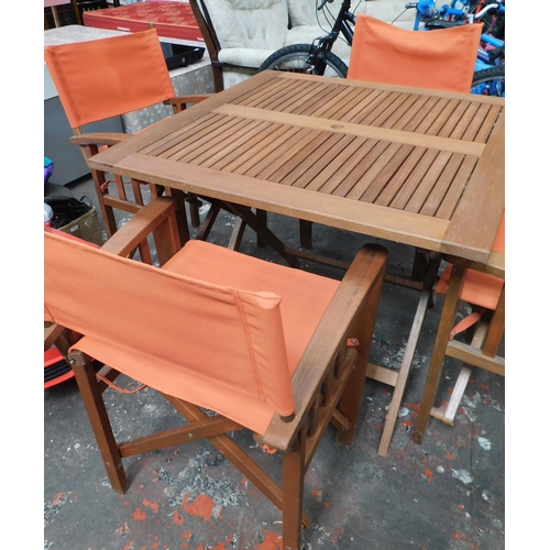 610 - Wooden patio set with four chairs - one as seen