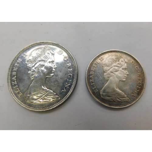 242 - 1966 Voyager Canadian dollar and 50 cent coin