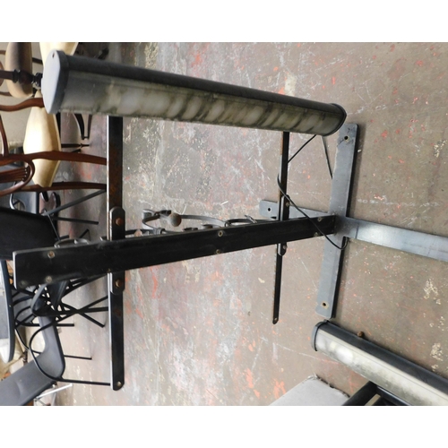 437 - Wrought iron pub/shop frame and hanger with lights - unchecked, approx. 49