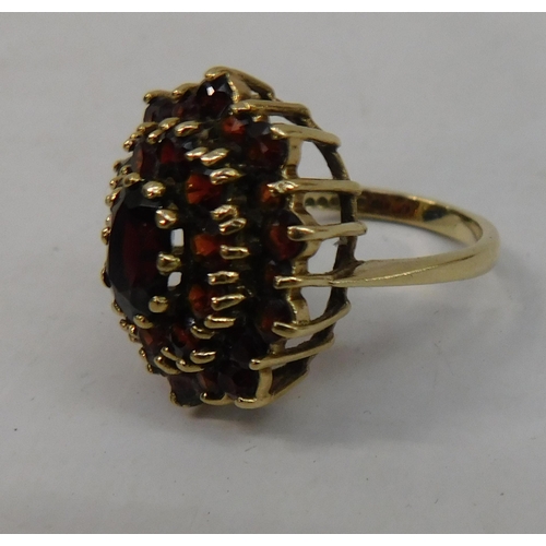 420 - 9ct Gold large three tier garnet cluster ring - size P, combine weight 6.04g