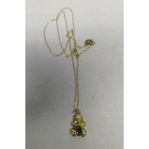 498 - 9ct Gold chain with teddy bear pendant set - with a blue topaz, weight 0.7g