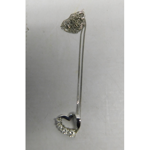 502 - 9ct White gold chain and floating heart pendant set with stones - weight 2.2g