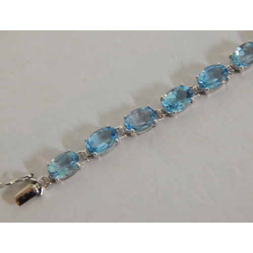 440 - 9ct White gold blue topaz tennis bracelet