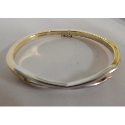 400 - 9ct Yellow and white gold criss-cross bangle