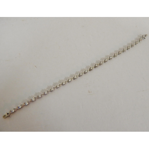 439 - 9ct White gold white stone 'hugs and kisses' tennis bracelet