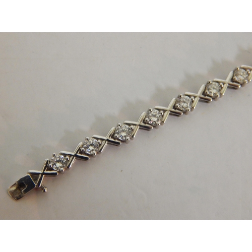 439 - 9ct White gold white stone 'hugs and kisses' tennis bracelet