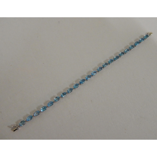 440 - 9ct White gold blue topaz tennis bracelet