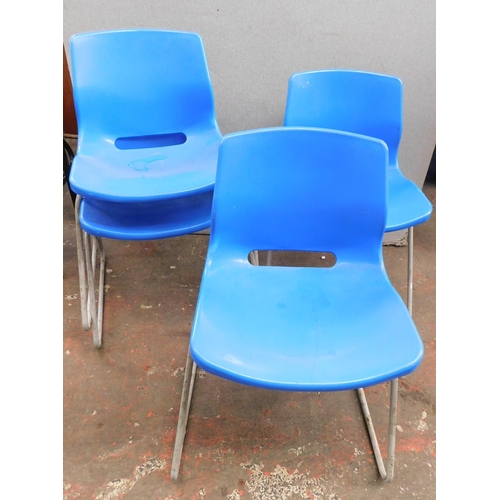 272 - Four blue plastic stacking chairs with metal frames