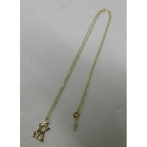 442 - 9ct Gold chain and 'K' pendant set with diamond - weight 1.16g