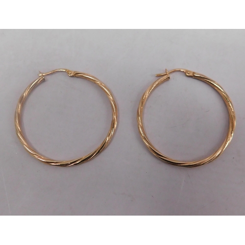 396 - Pair of 9ct gold large hoop earrings - weight 1.10g