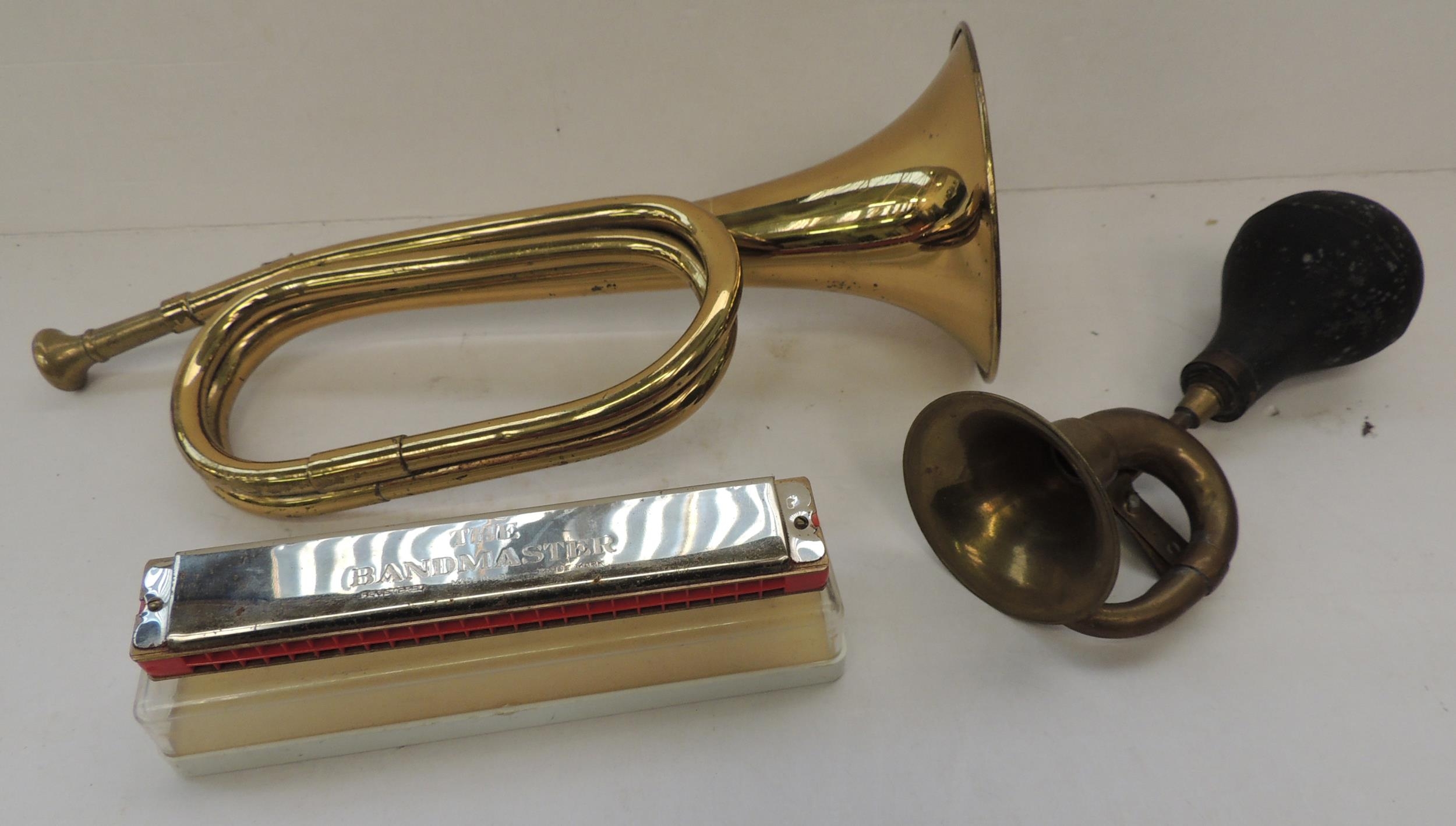 Selection of musical instruments including Harmonica, horn and bugle