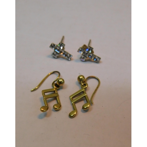 481A - Two pairs of 9ct gold earrings; musical notes and white stone cross studs - 1.2g