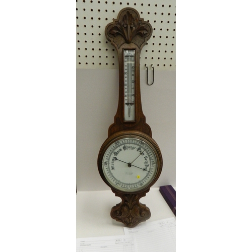 262 - Antique Victorian carved oak aneroid wheel barometer