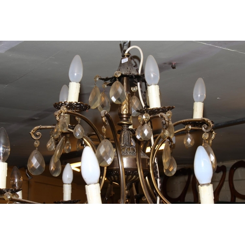 120 - Large gilt metal sixteen branch chandelier with glass tear drop to each branch and cup.