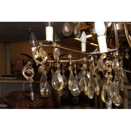 120 - Large gilt metal sixteen branch chandelier with glass tear drop to each branch and cup.