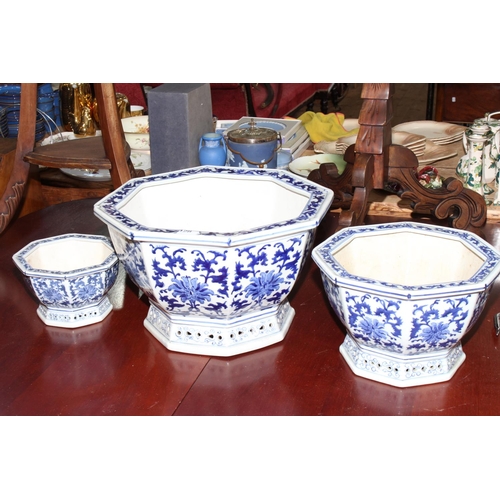 128 - Set of three blue and white Oriental design octagonal pottery planters decorated with Oriental desig... 