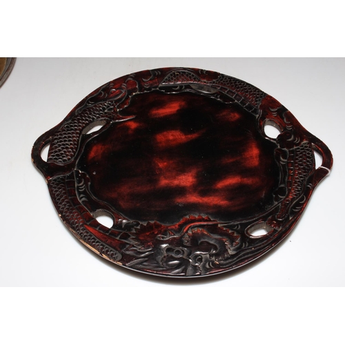 164 - Oriental etched metal circular tray and carved hardwood Chinese dragon tray.