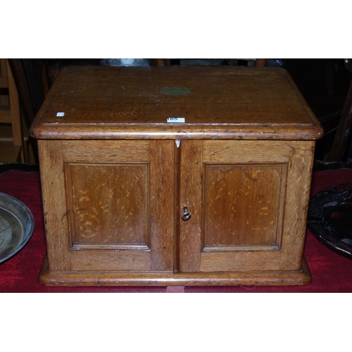 165 - Oak table part canteen of cutlery having double doors concealing four drawers with brass fittings, 5... 