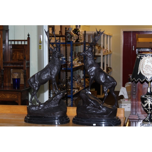 179 - Pair of large impressive bronze stags on rocky outcrops with marble bases, 74cm high.