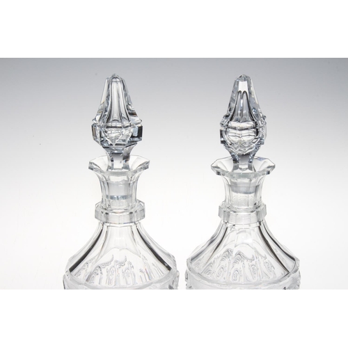 195 - Pair of Baccarat moulded body decanters and stoppers, 32cm high, one ill fitting stopper.