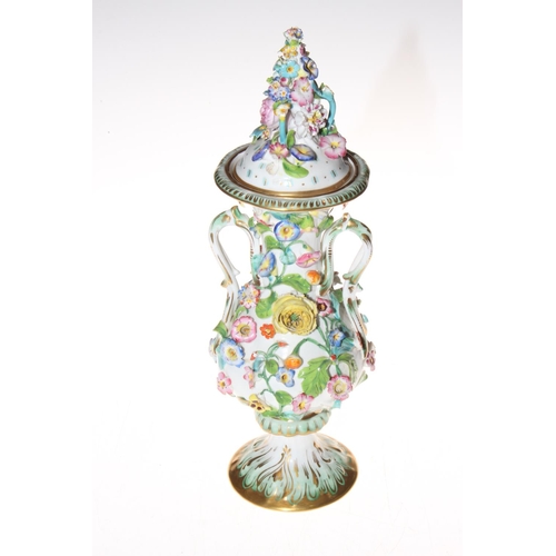 203 - Continental flower encrusted vase and cover, 32cm. Condition: Good save for some petal chips common ... 