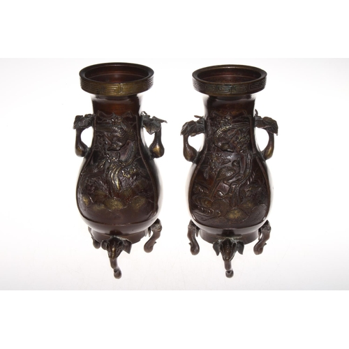 214 - Pair bronze two handle vases with gilt highlighted relief panels of birds and blossom and on elephan... 